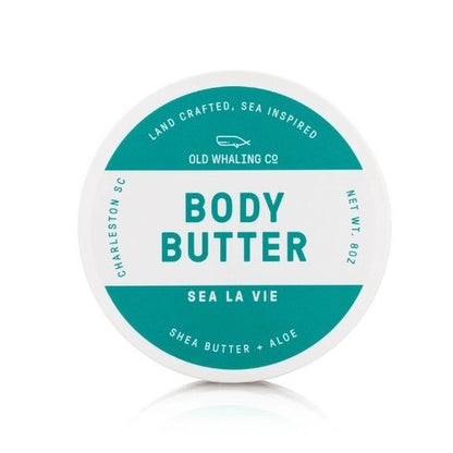 Round body butter container with teal label, "Sea La Vie," shea butter and aloe.