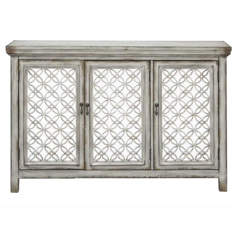 Vintage gray cabinet with ornate geometric doors.
