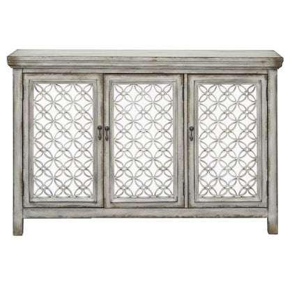 Vintage gray cabinet with ornate geometric doors.