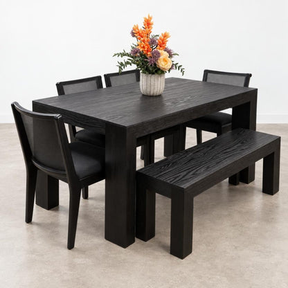 Dark dining set with chairs, bench, and floral centerpiece.