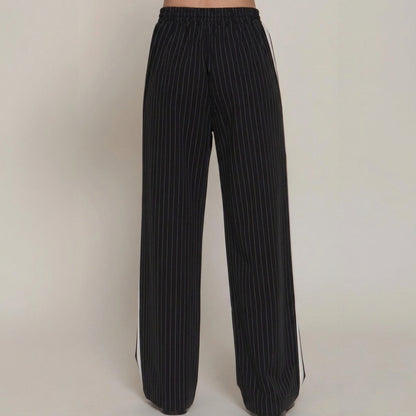 Black pinstriped wide-leg pants with elastic waistband.