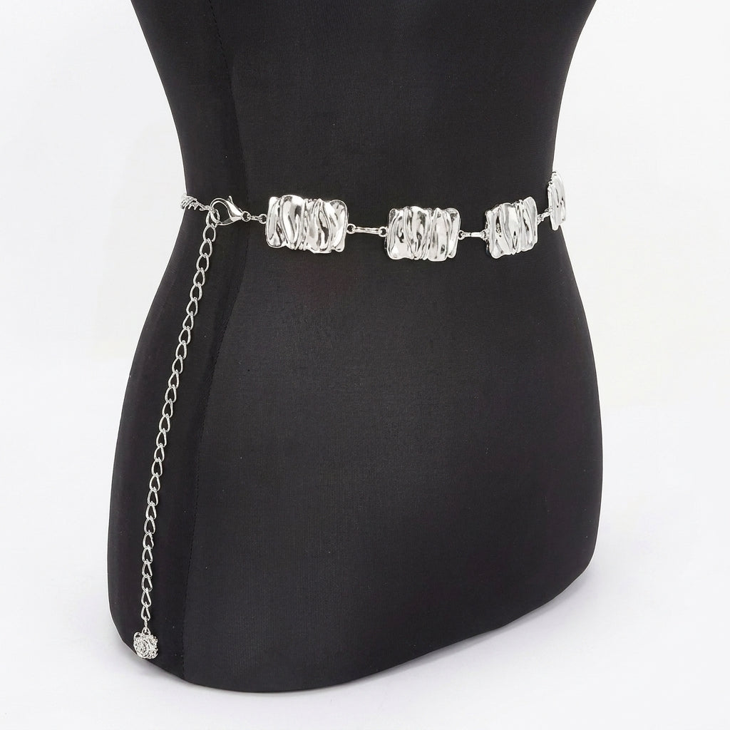 Silver chain belt on a black mannequin.