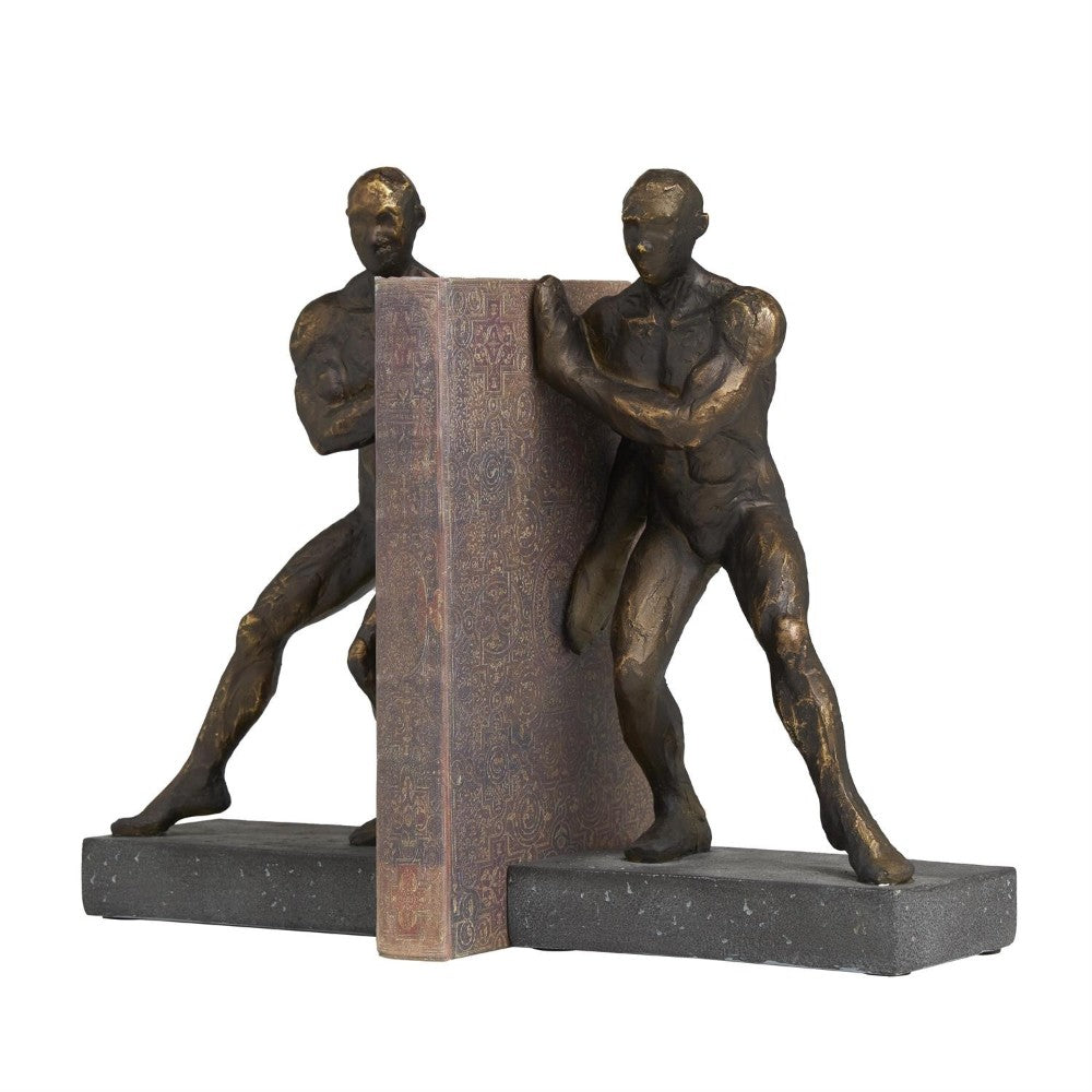 Two bronze human figures support a decorative book as bookends.