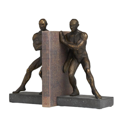 Two bronze human figures support a decorative book as bookends.