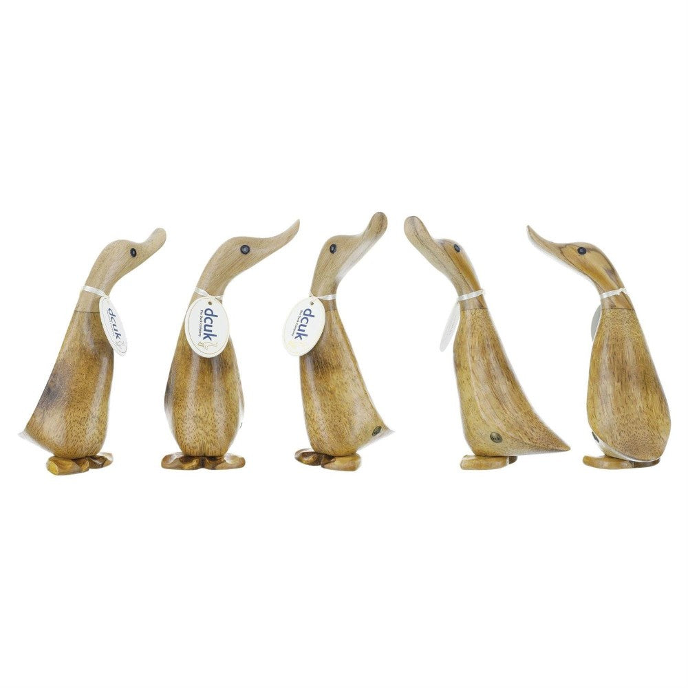 Five carved wooden ducks with tags on their necks.