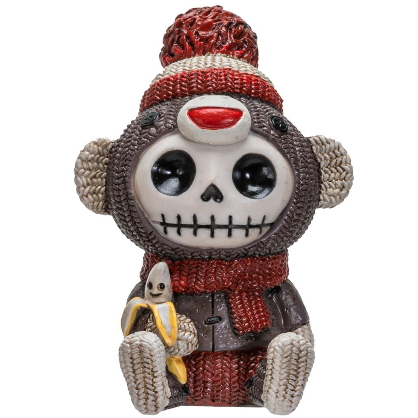 Skeleton monkey figurine with knitted hat, scarf, and banana.