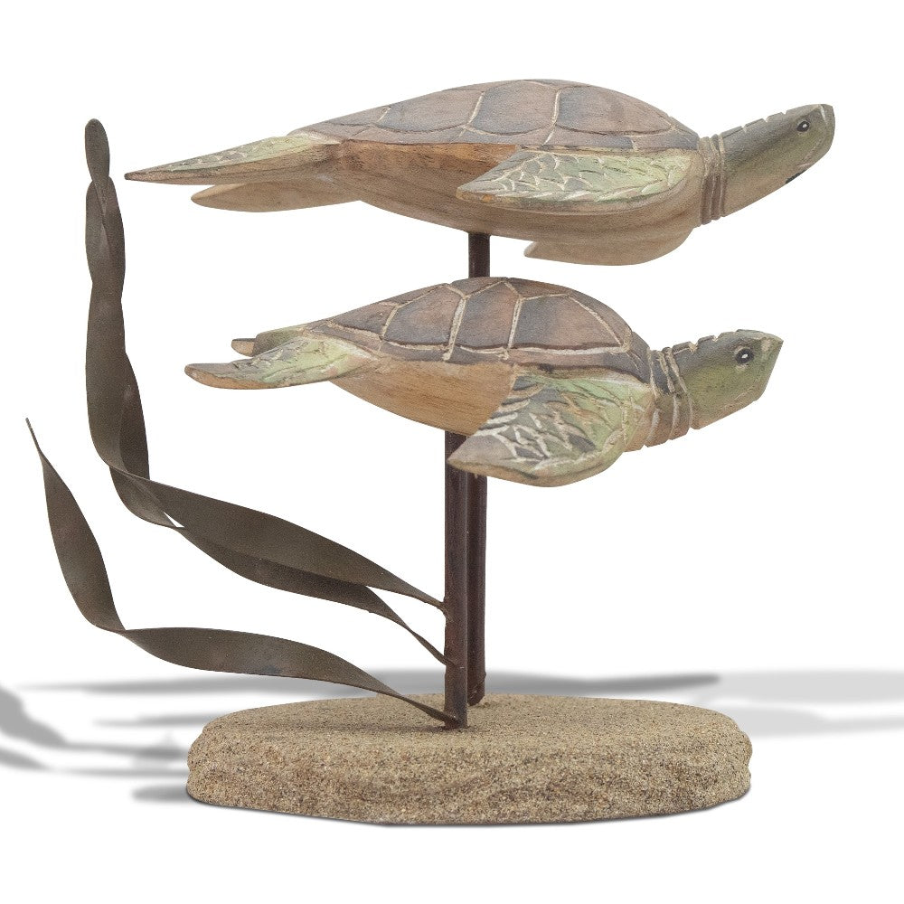 Wooden sea turtles swimming above sand with metal seaweed accents.