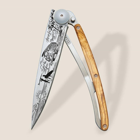 Folding knife with engraved blade and wooden handle.