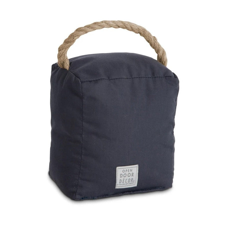 Dark fabric doorstop with a rope handle and a small label.