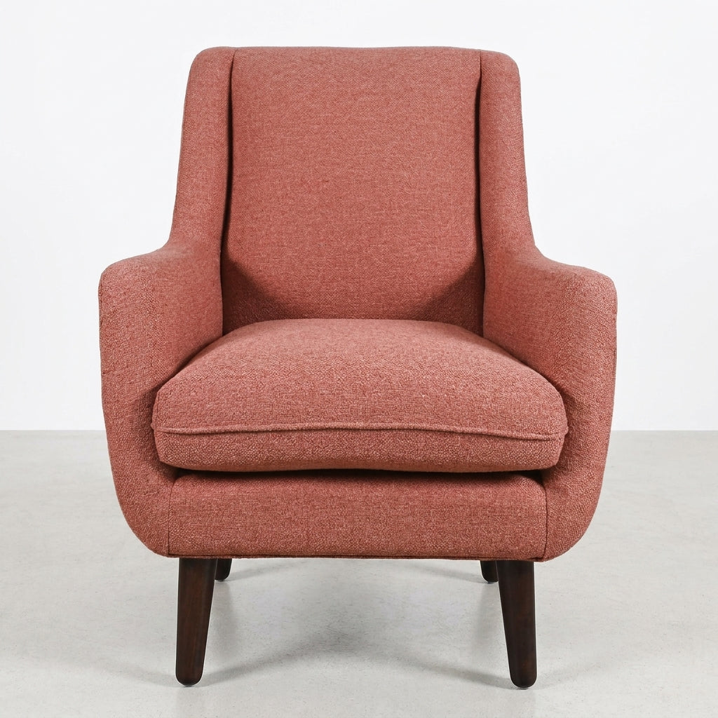 Red upholstered armchair with wooden legs, front view.