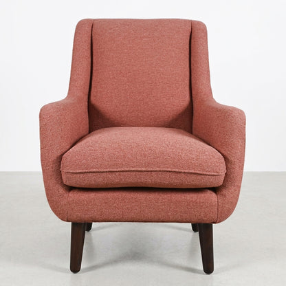 Red upholstered armchair with wooden legs, front view.