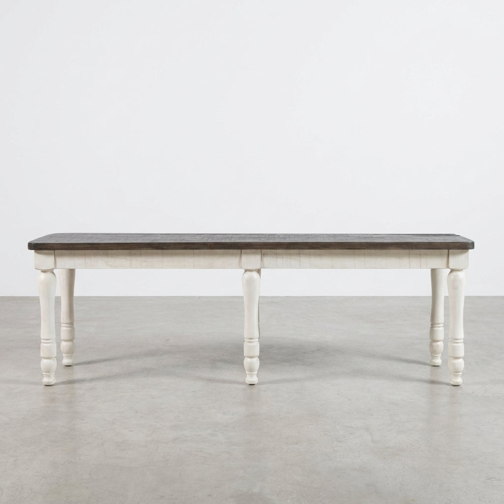 Wooden table with dark top and white turned legs.
