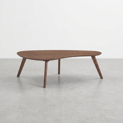 Wooden coffee table with unique asymmetrical design and four angled legs.