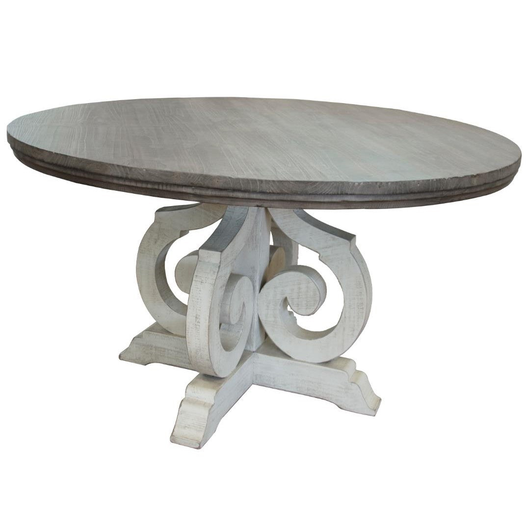 Round table with ornate, scrollwork pedestal base.
