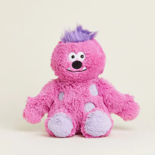 Pink plush monster toy with purple hair and big googly eyes.