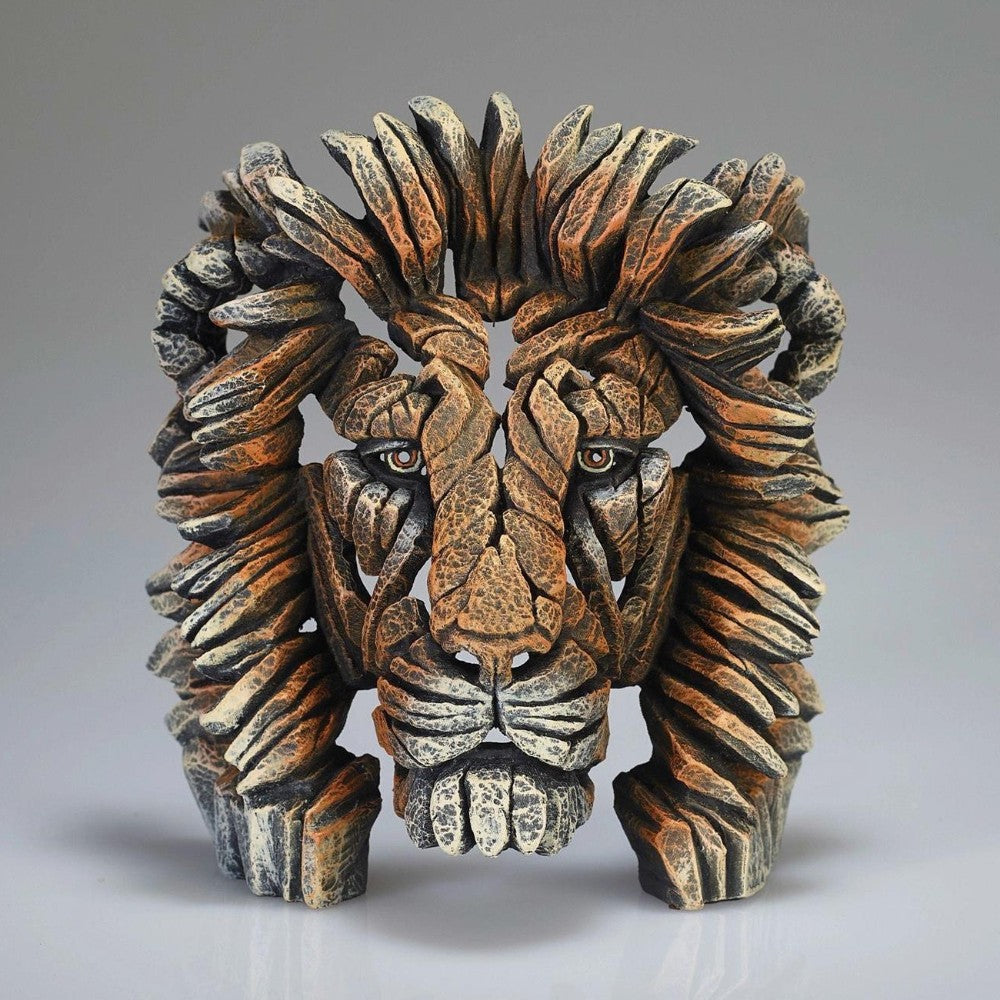 Wooden lion head sculpture with intricate carvings.