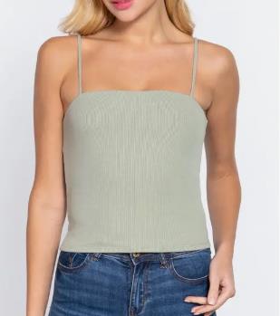 Person in sage green camisole and blue jeans.