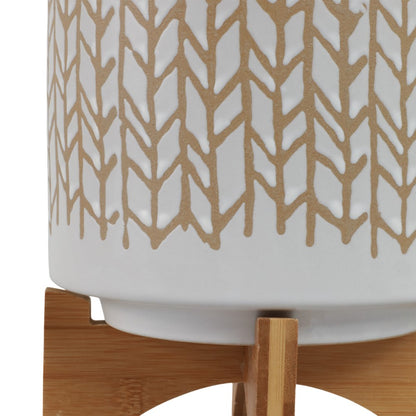 White ceramic pot with brown geometric pattern on a wooden stand.