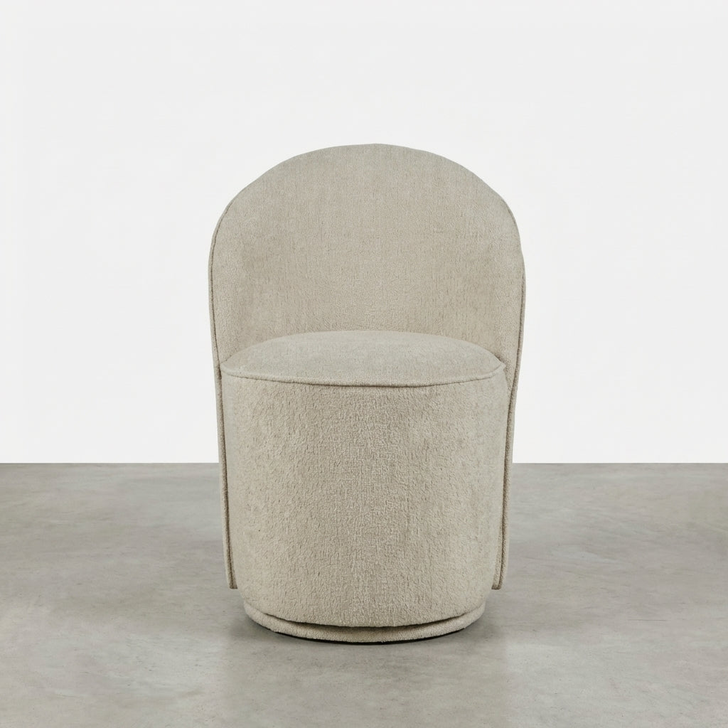 Beige curved chair with soft, round design.