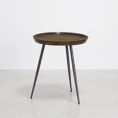 Round wood top table with black metal legs.
