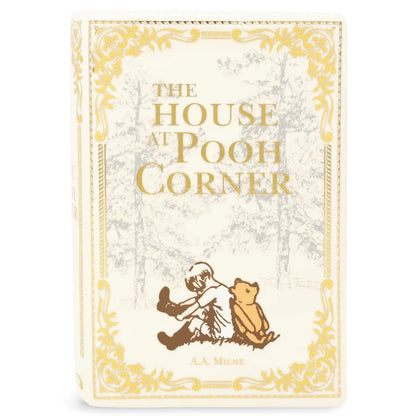 Vintage book cover of "The House at Pooh Corner" with gold accents.