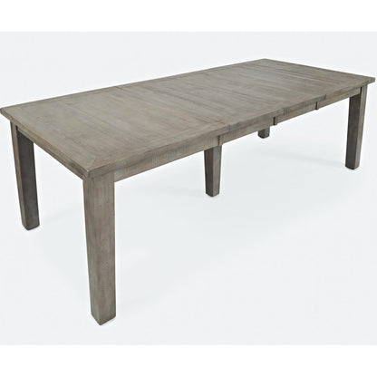 Long wooden dining table on a white background.