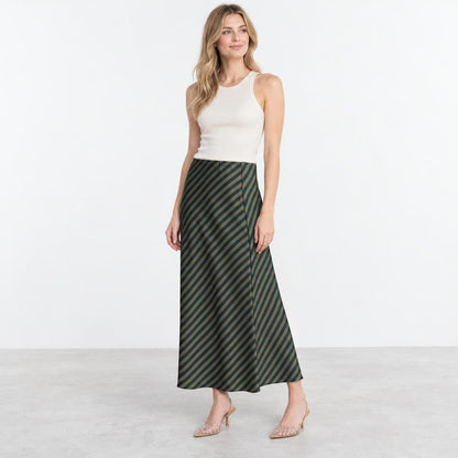 Model wearing a white tank top, striped maxi skirt, and embellished heels.