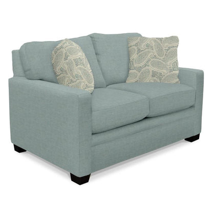 Light blue loveseat with patterned pillows.
