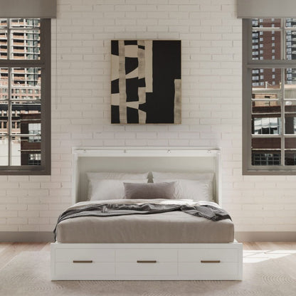Modern bedroom with a white bed and abstract wall art.
