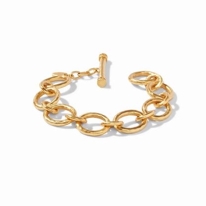 A chunky gold chain bracelet with a toggle clasp, displayed on a white background.