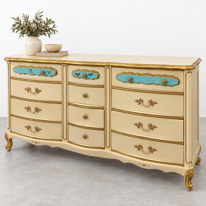 An ornate cream-and-gold dresser with turquoise accents, topped with a potted plant and bowl.