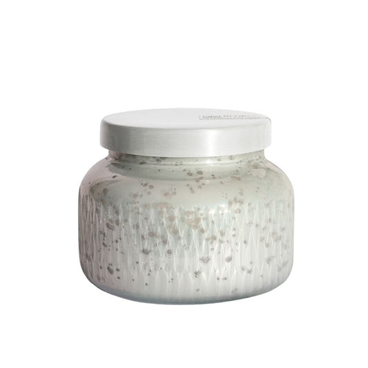 Textured gray jar candle with silver lid.