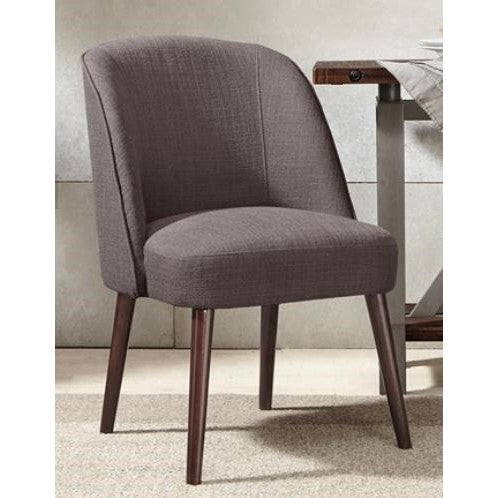Gray upholstered chair with wooden legs by a table.