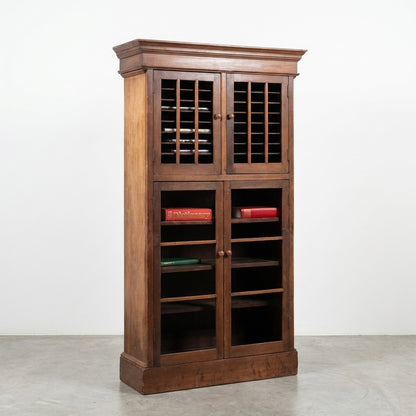 Tall wooden bookshelf with books and shutter-style doors.