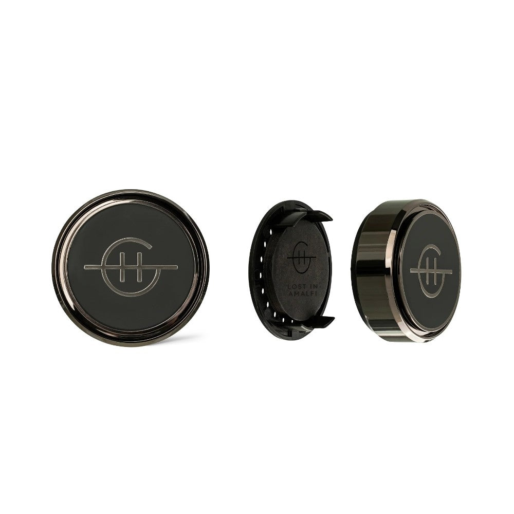 Three round black car vent clips with a sleek logo design.