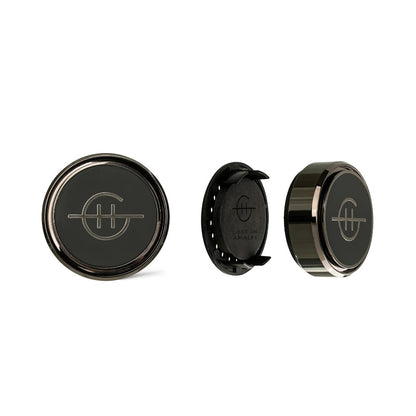 Three round black car vent clips with a sleek logo design.