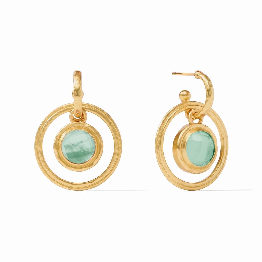 Gold hoop earrings featuring round pale green stones in circular settings.