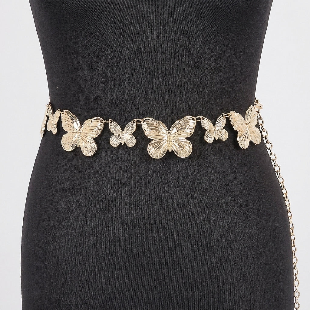 Gold butterfly belt on a black dress.