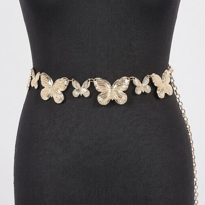 Gold butterfly belt on a black dress.