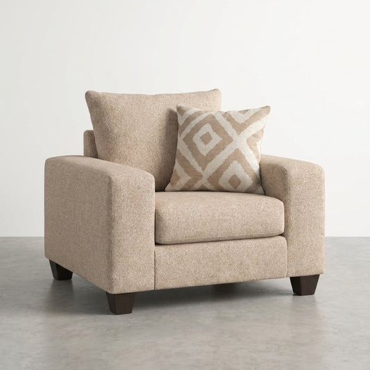 Beige armchair with a geometric-patterned pillow.