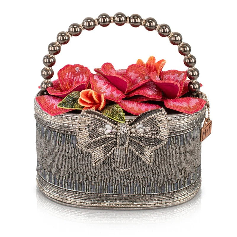 Beaded handbag with floral design and a bow, featuring a pearl handle.