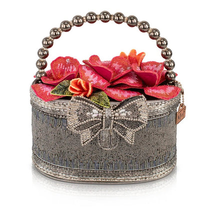 Beaded handbag with floral design and a bow, featuring a pearl handle.