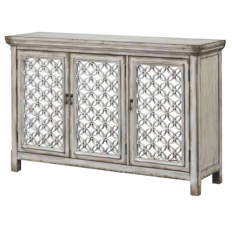 Vintage cabinet with ornate, circular-patterned doors.