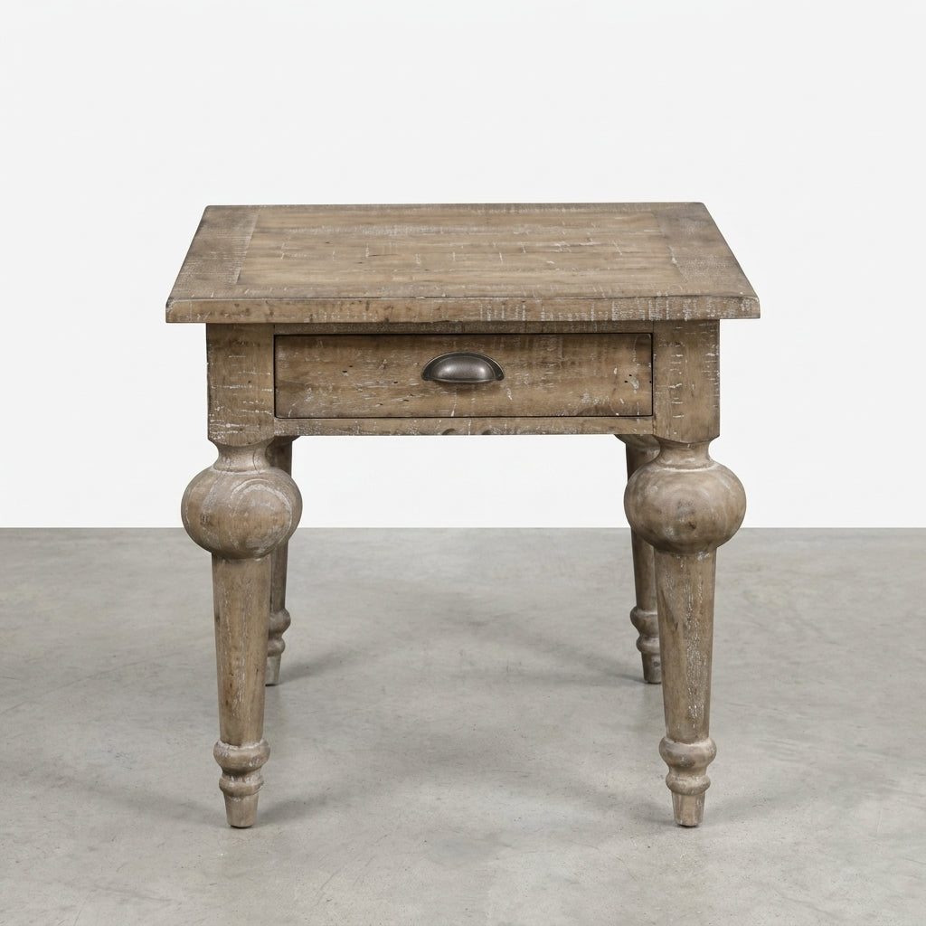 Rustic wooden side table with a drawer and ornate legs.