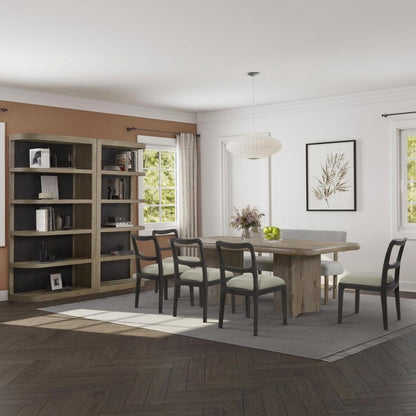 Modern dining room with table, chairs, bookcase, and wall art.