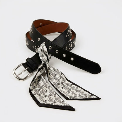 Studded black belt with a tied patterned scarf.