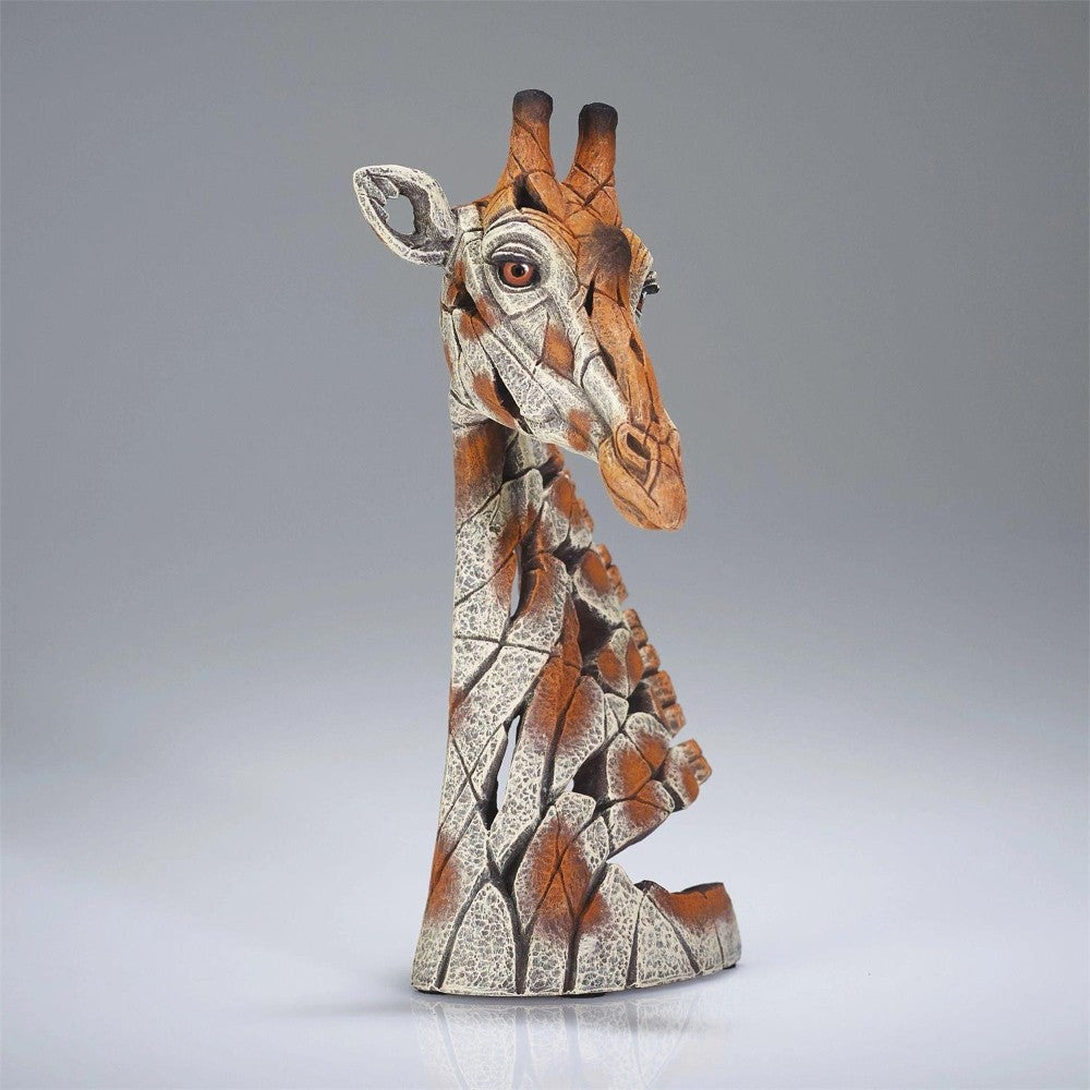 Abstract giraffe sculpture with cracked, textured surface.