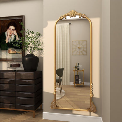Elegant room with a gold-framed mirror and art on the wall.