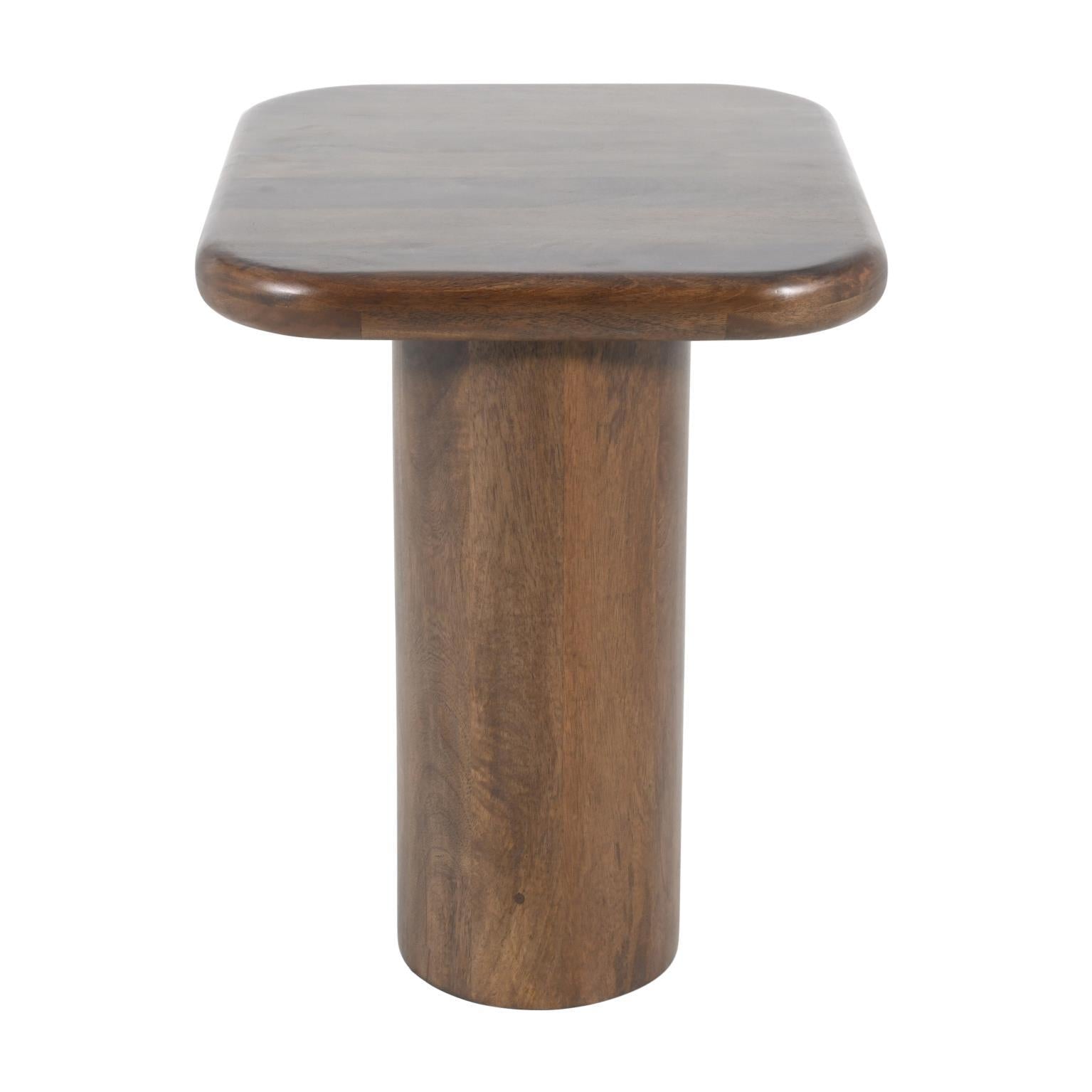 Wooden pedestal table with a smooth, rounded rectangular top.