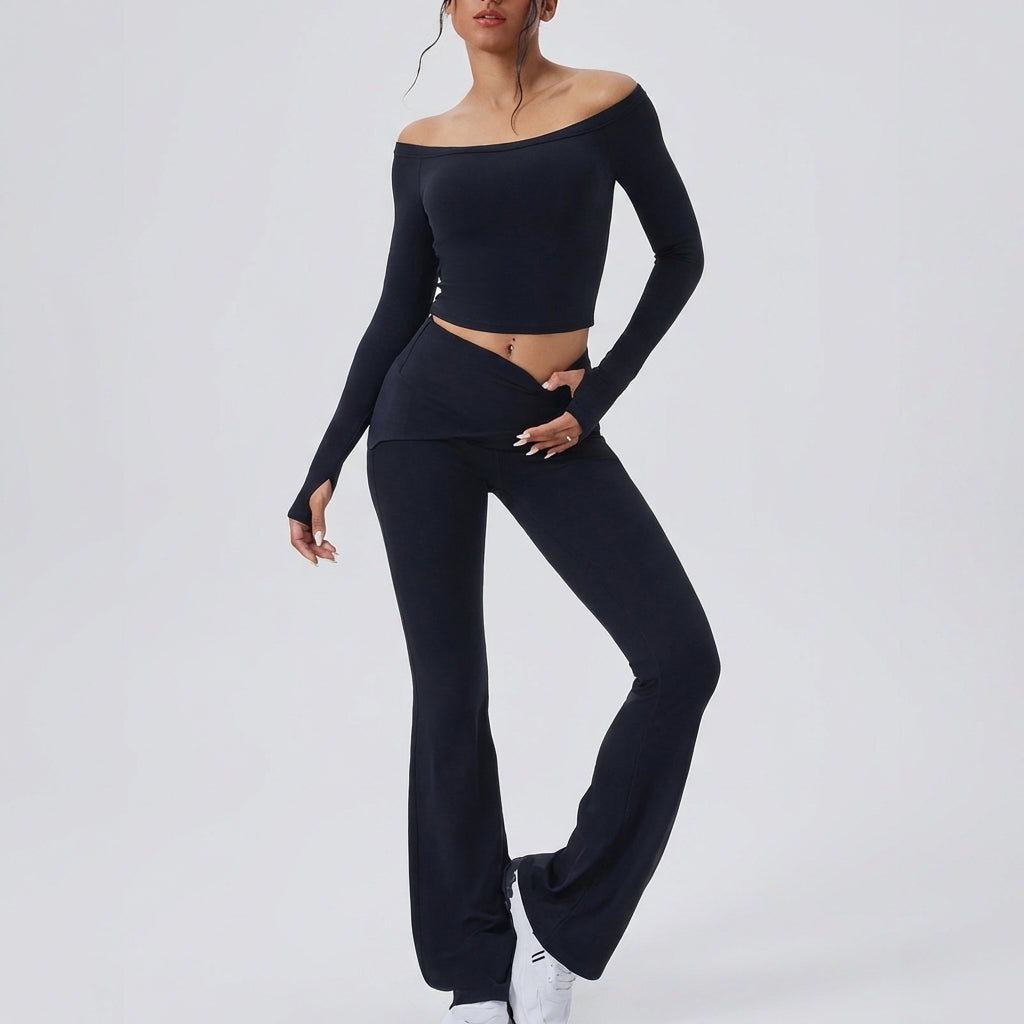 Person in stylish black off-shoulder outfit with sneakers.